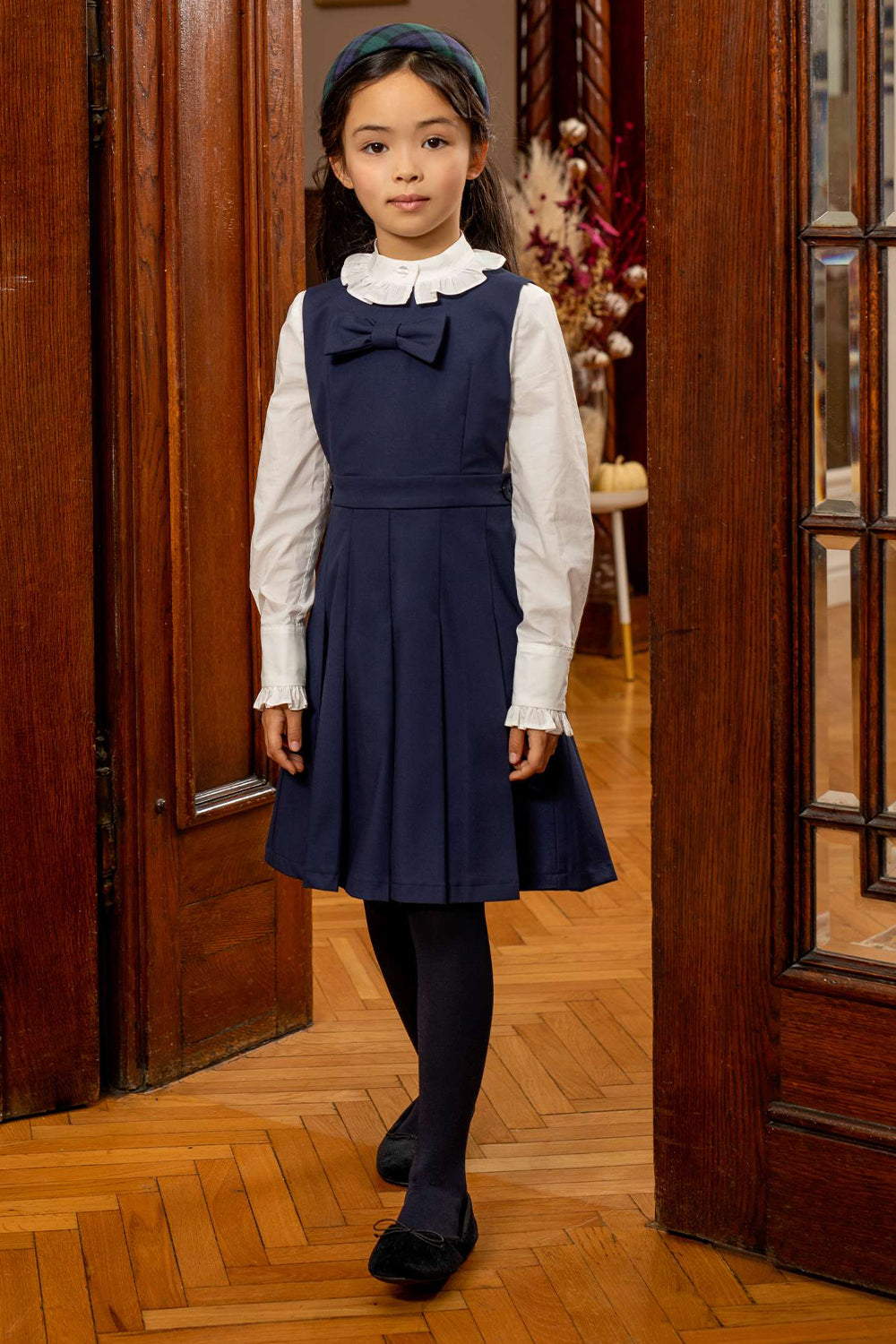 Blue poly viscose pinafore dress with bow and branded mother of pearl buttons