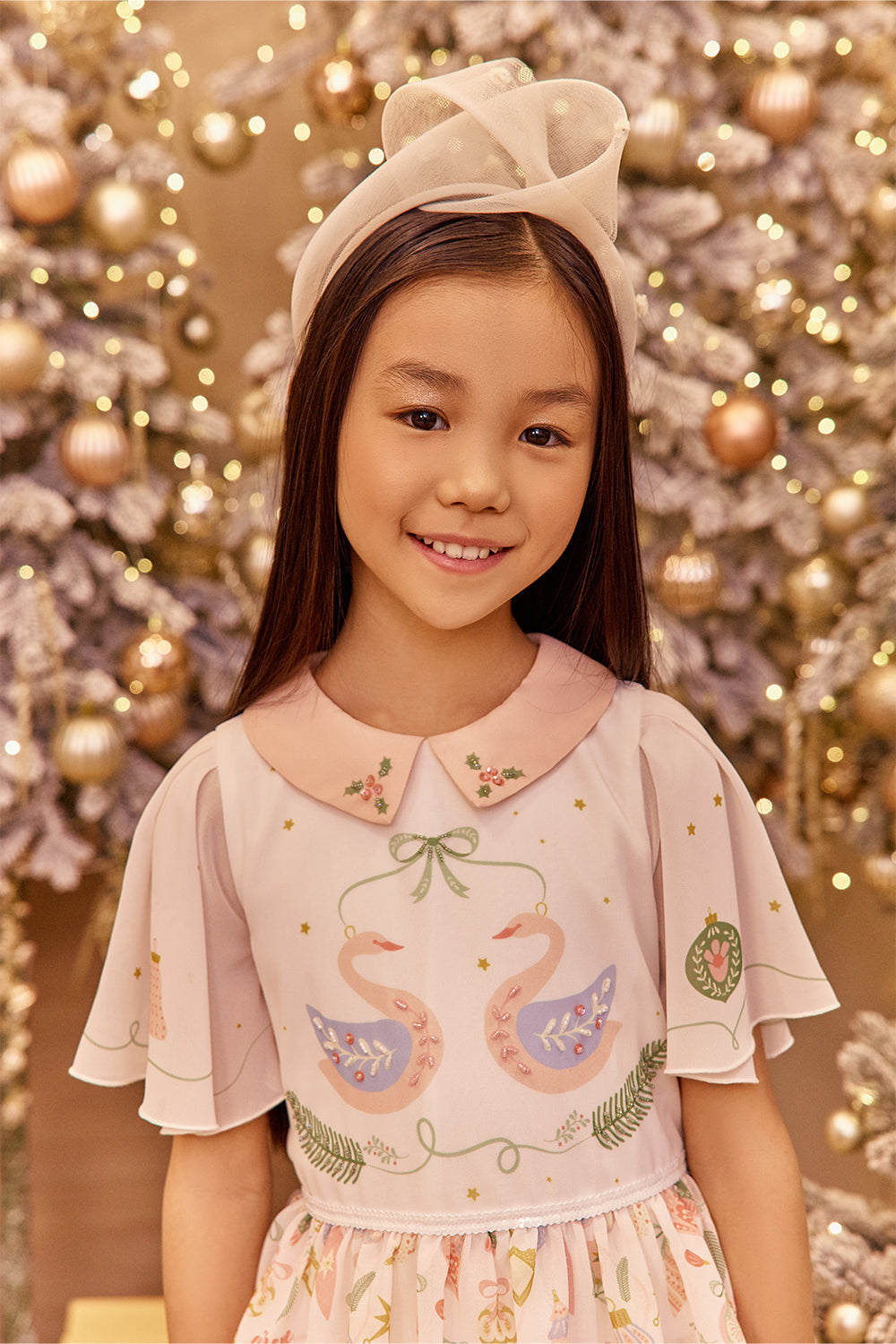Young girl in a decorated room with Christmas tree and lights