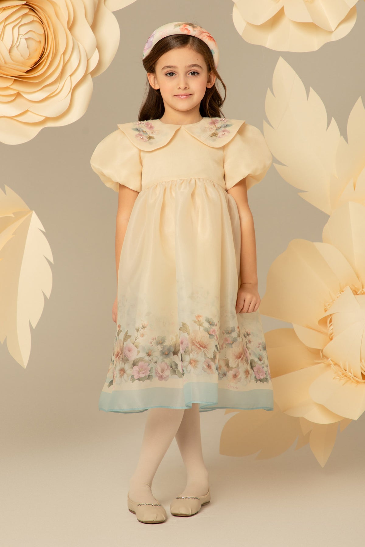 Girl wearing a cream floral organza midi dress