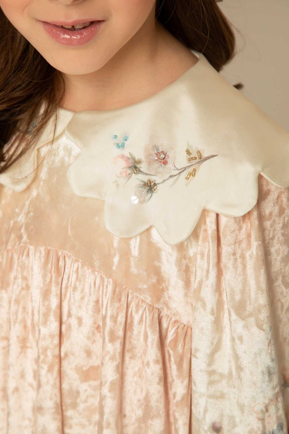 Close view of the hand-embroidered scalloped collar