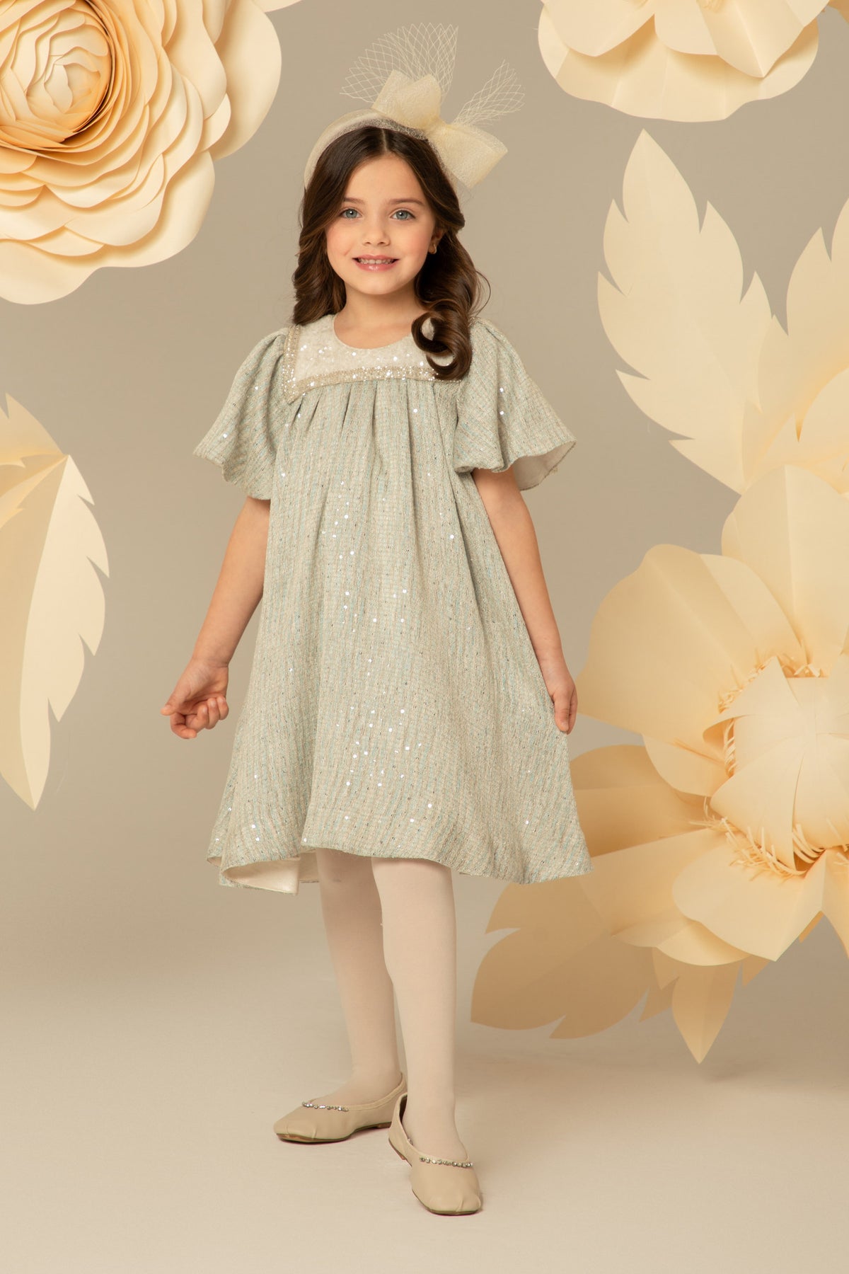 Girl wearing a blue A-line dress with a beaded yoke