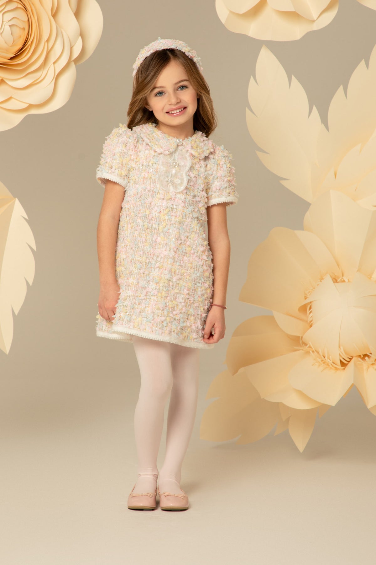 Girl wearing a pastel tweed dress with a Peter Pan collar
