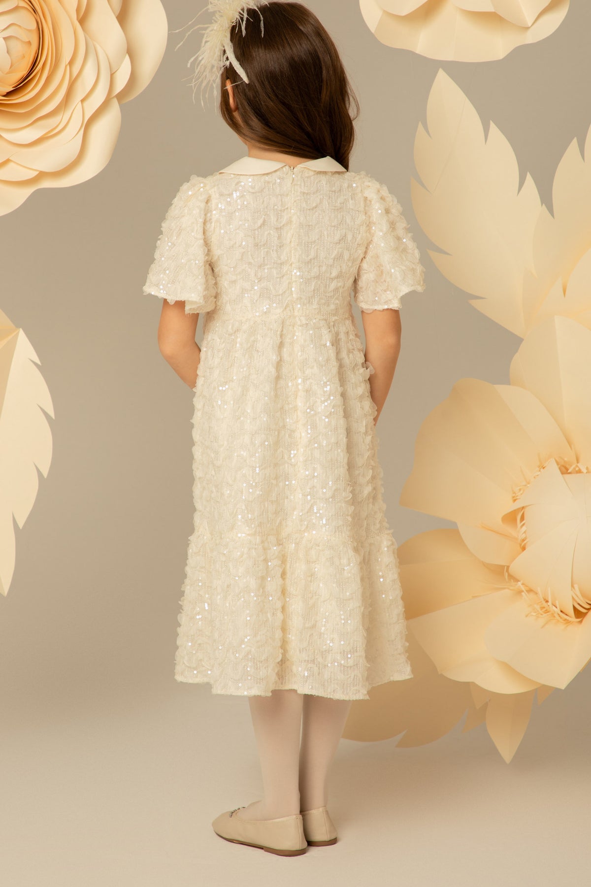 Back view of an ivory sequinned midi dress