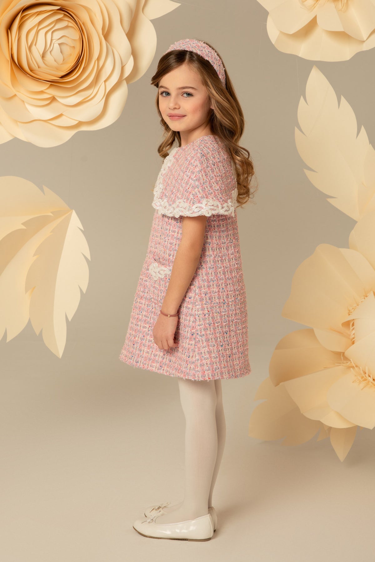 Side view of a pink tweed dress with cape collar