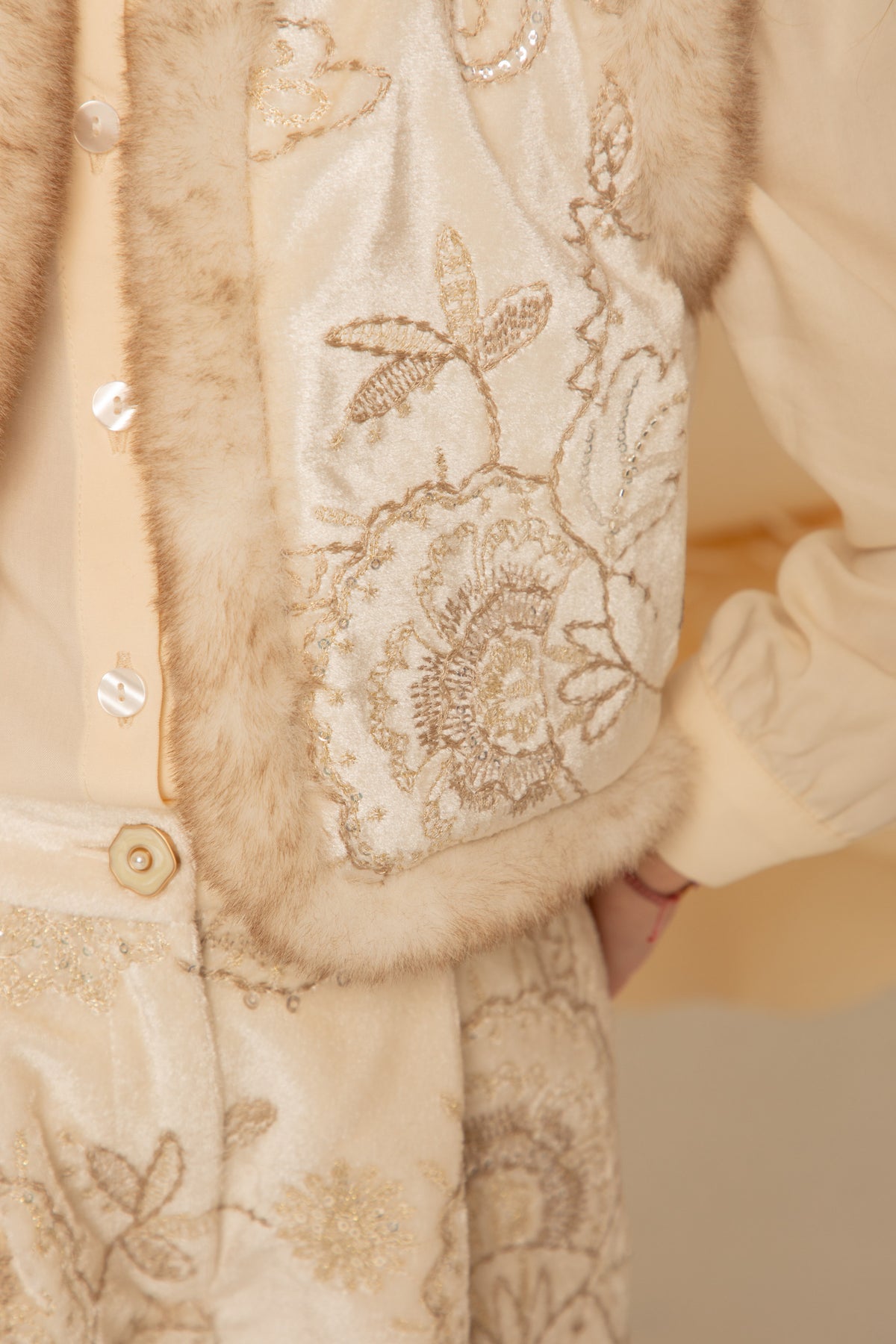 Close-up of the golden floral embroidery