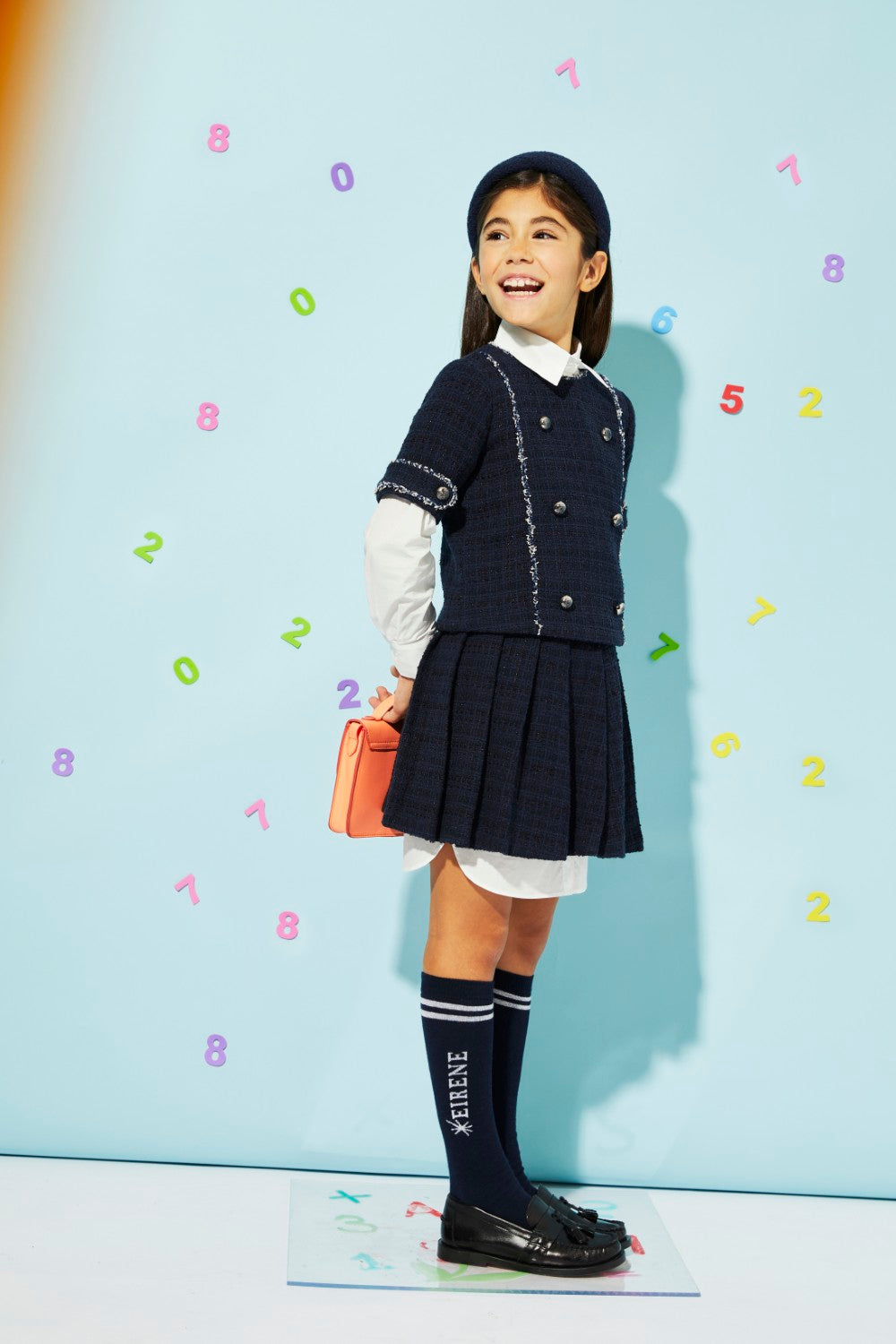 Blue woven tweed top with buttons, featuring a rich texture and versatile color.