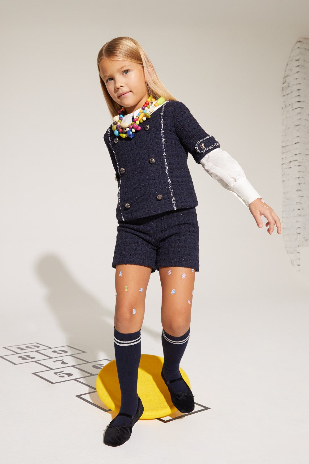 Blue woven tweed shorts, a designer kids clothing item, with a soft texture.