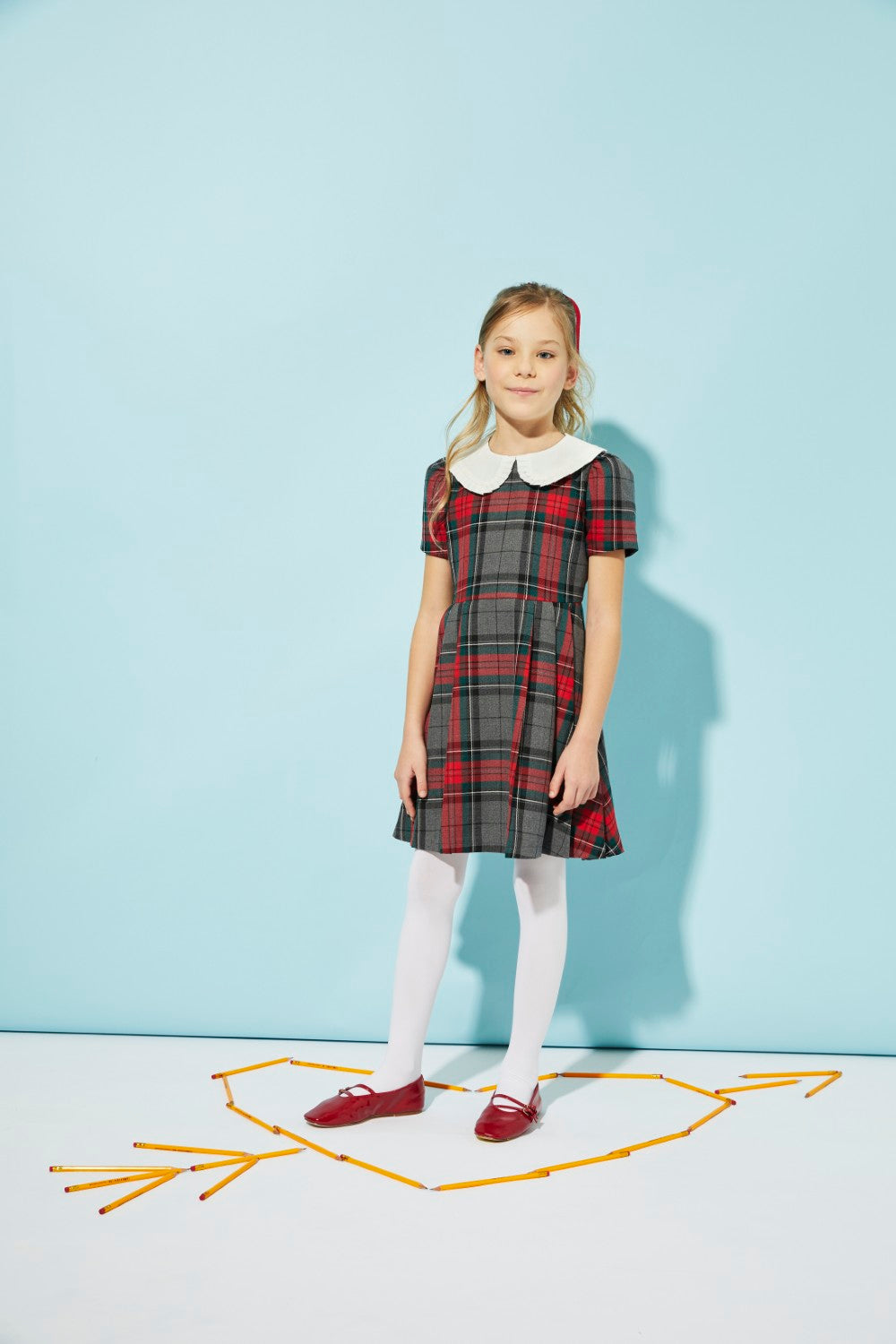 Girls' woven grey and red plaid dress with white collar for special occasion.