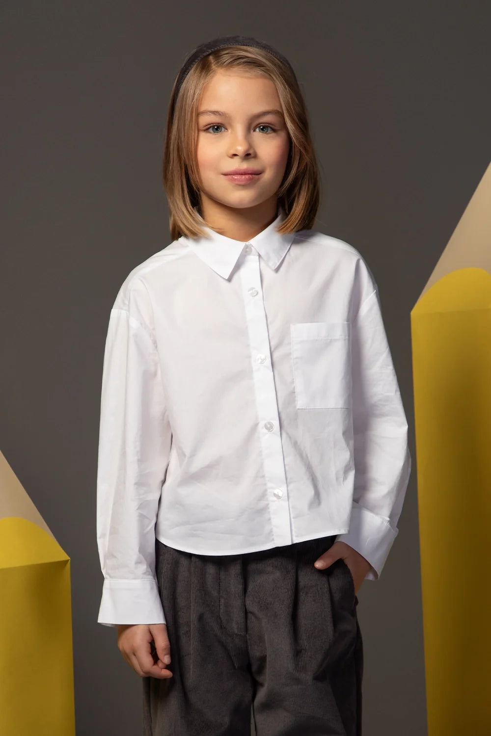 White oversized button-down shirt with a structured collar and wide cuffs