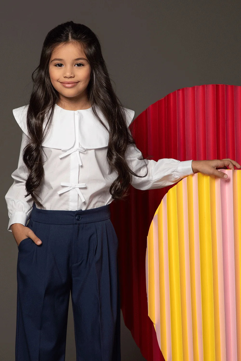 White blouse with shoulder ruffles, bows and oversized rounded collar