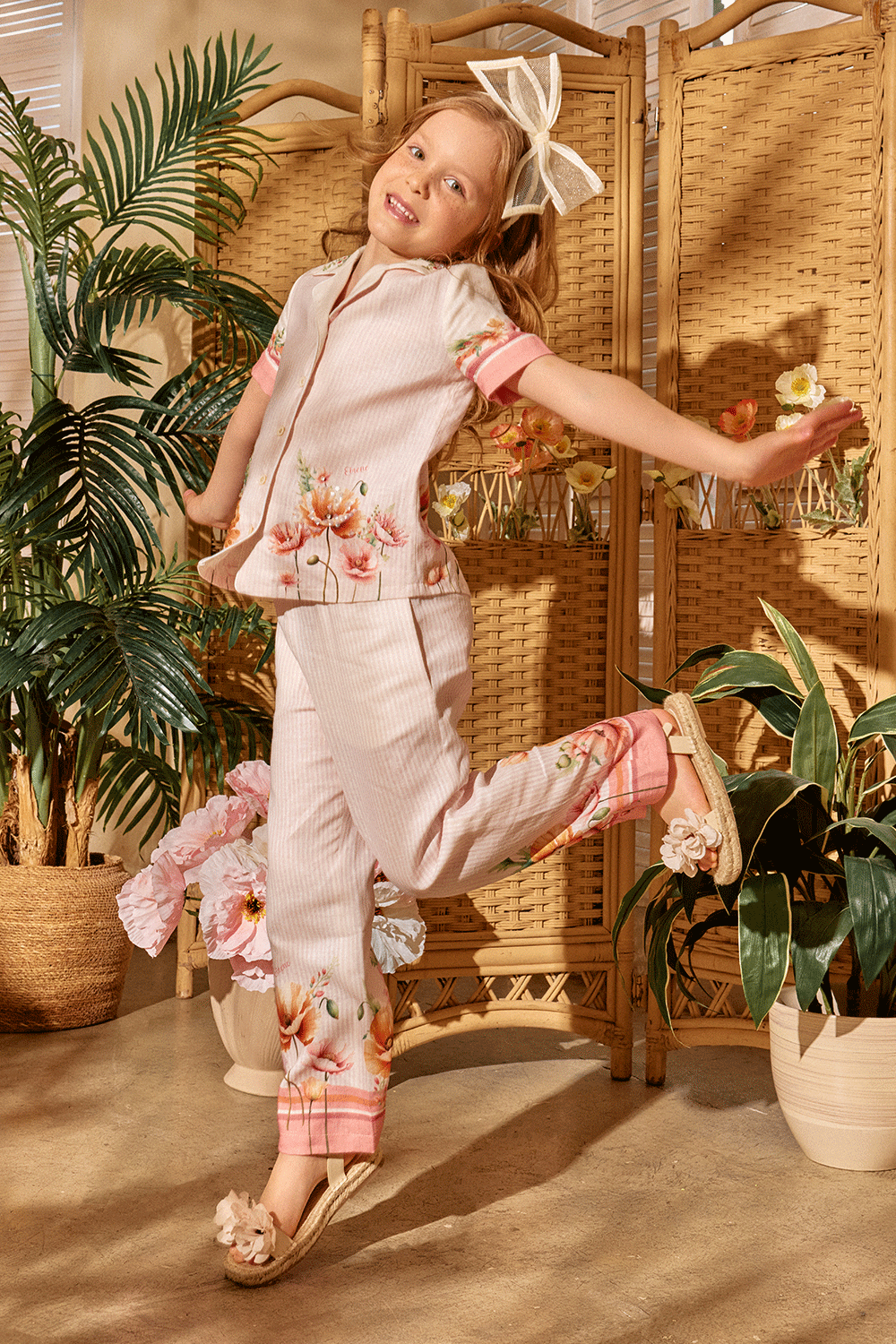 Soft pink striped set featuring a short-sleeve button-up shirt and matching pants with floral print and hand-embellished front