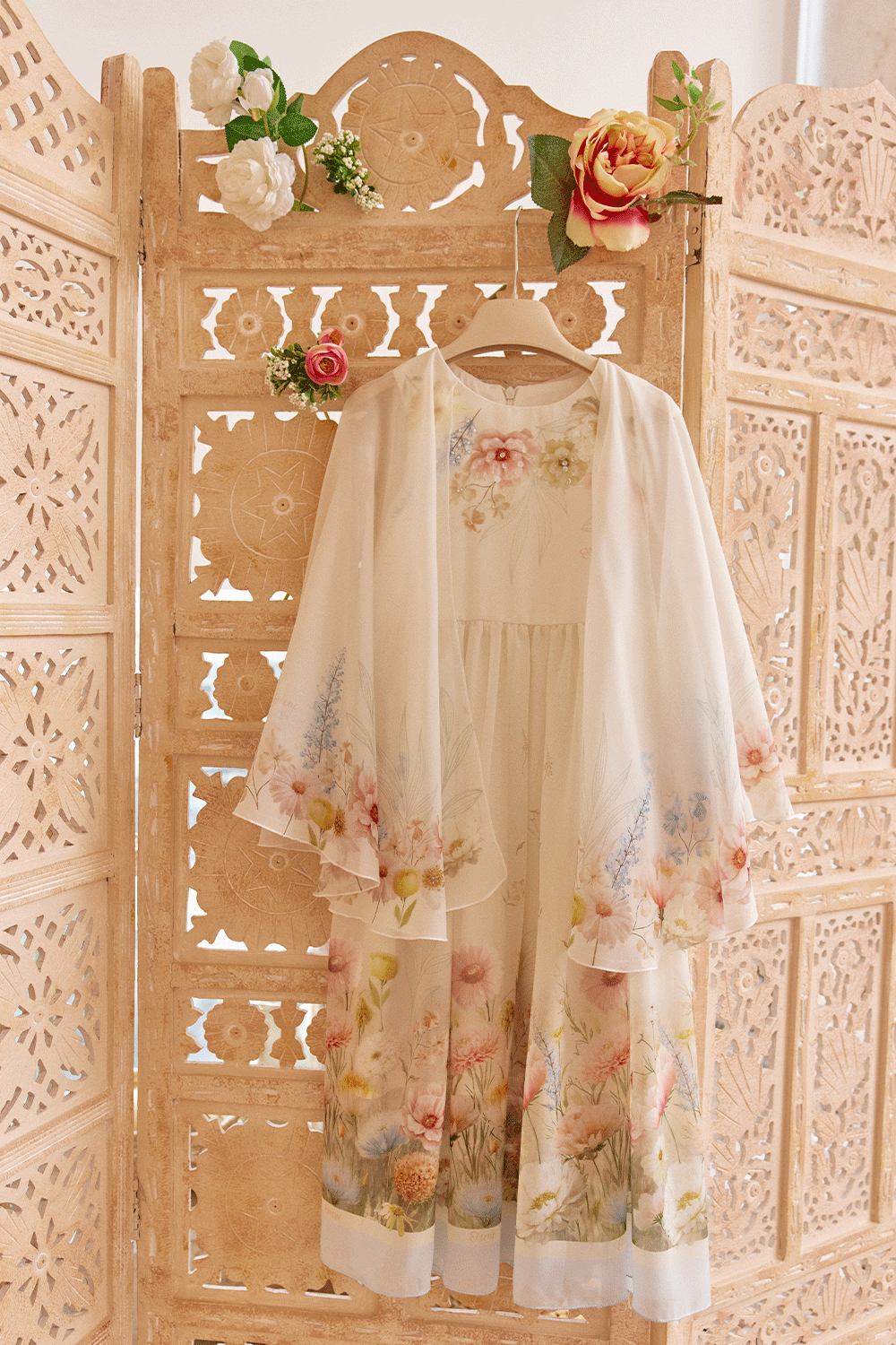 White chiffon dress with floral print, flowing sleeves and delicate hand-embelishement