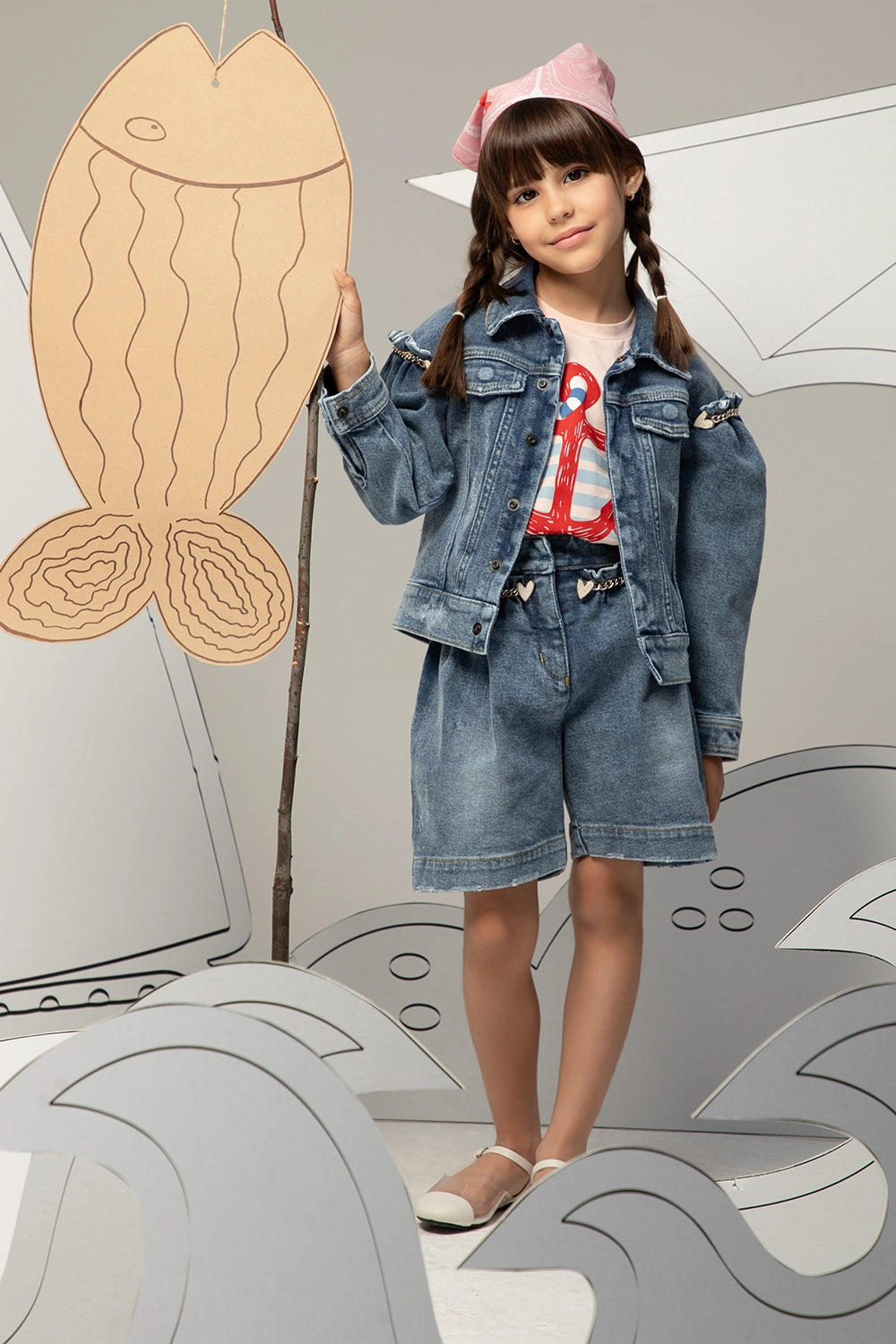 High-waisted denim shorts with a ruffled waistband, heart charm chain, and a relaxed, wide-leg fit