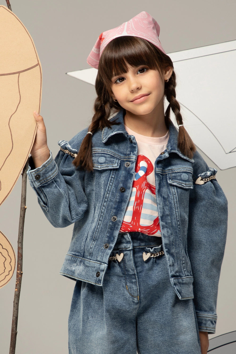 Pink t-shirt with light blue stripes and a large red anchor print