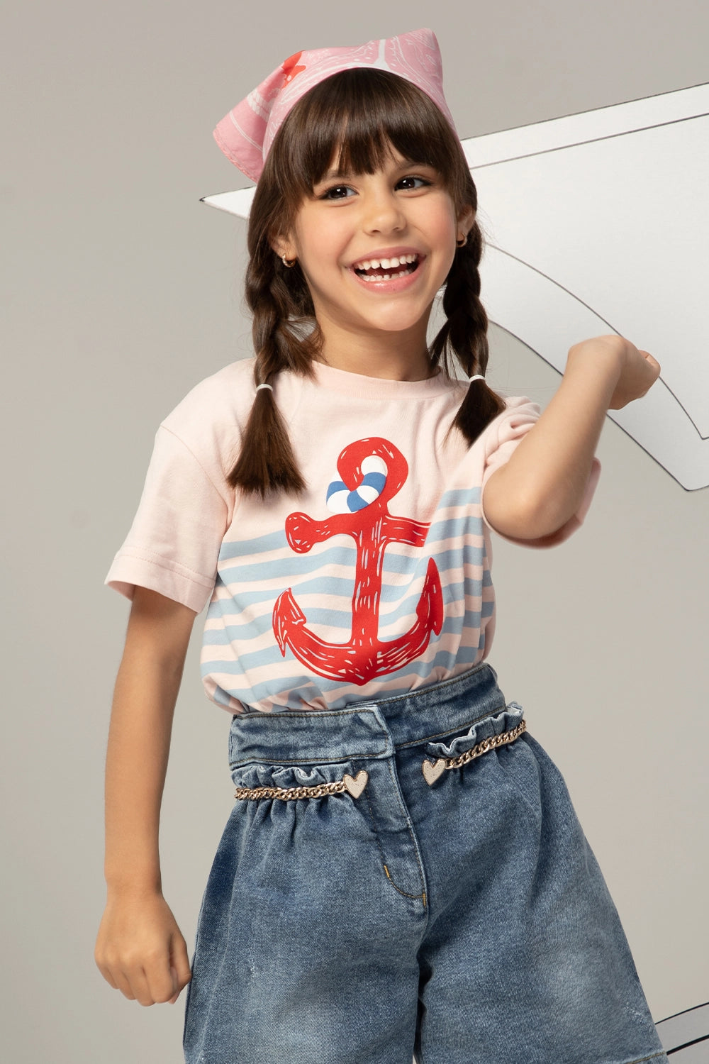 Pink t-shirt with light blue stripes and a large red anchor print