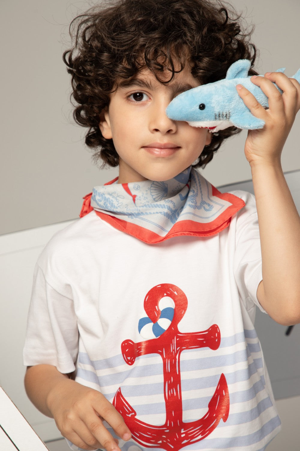 بنطال أزرق فاتح بأساور مخططة باللون الأبيض ونقش صغير لقارب شراعي على الساق