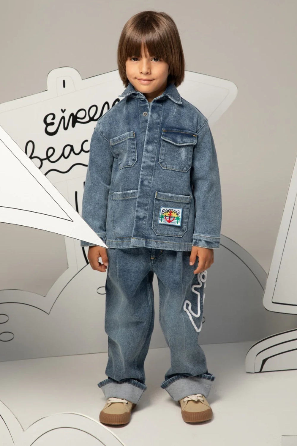 Denim jacket with classic collar, flap pockets, and colorful embroidered patch on the front