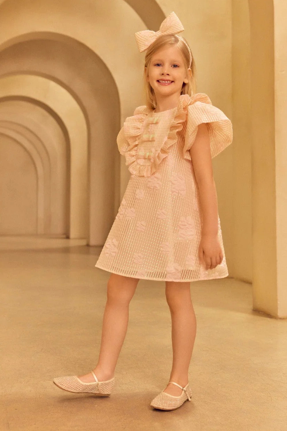 Charming A-line jacquard organza dress in light pink with voluminous ruffled shoulders and front shimmering bows in mint and pink