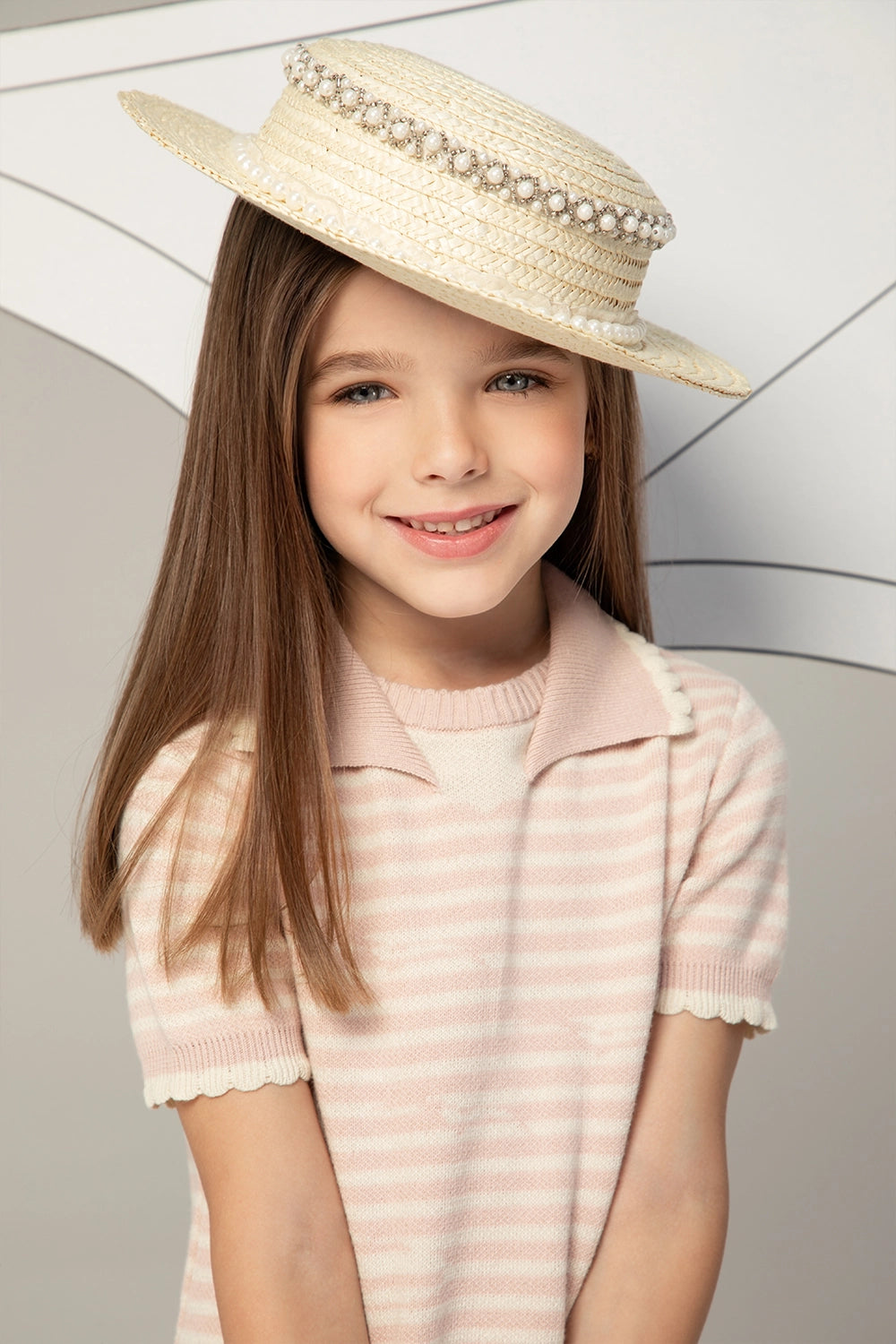 Light pink and white striped knit dress with short sleeves, collar detail, and subtle textured sailboat motif