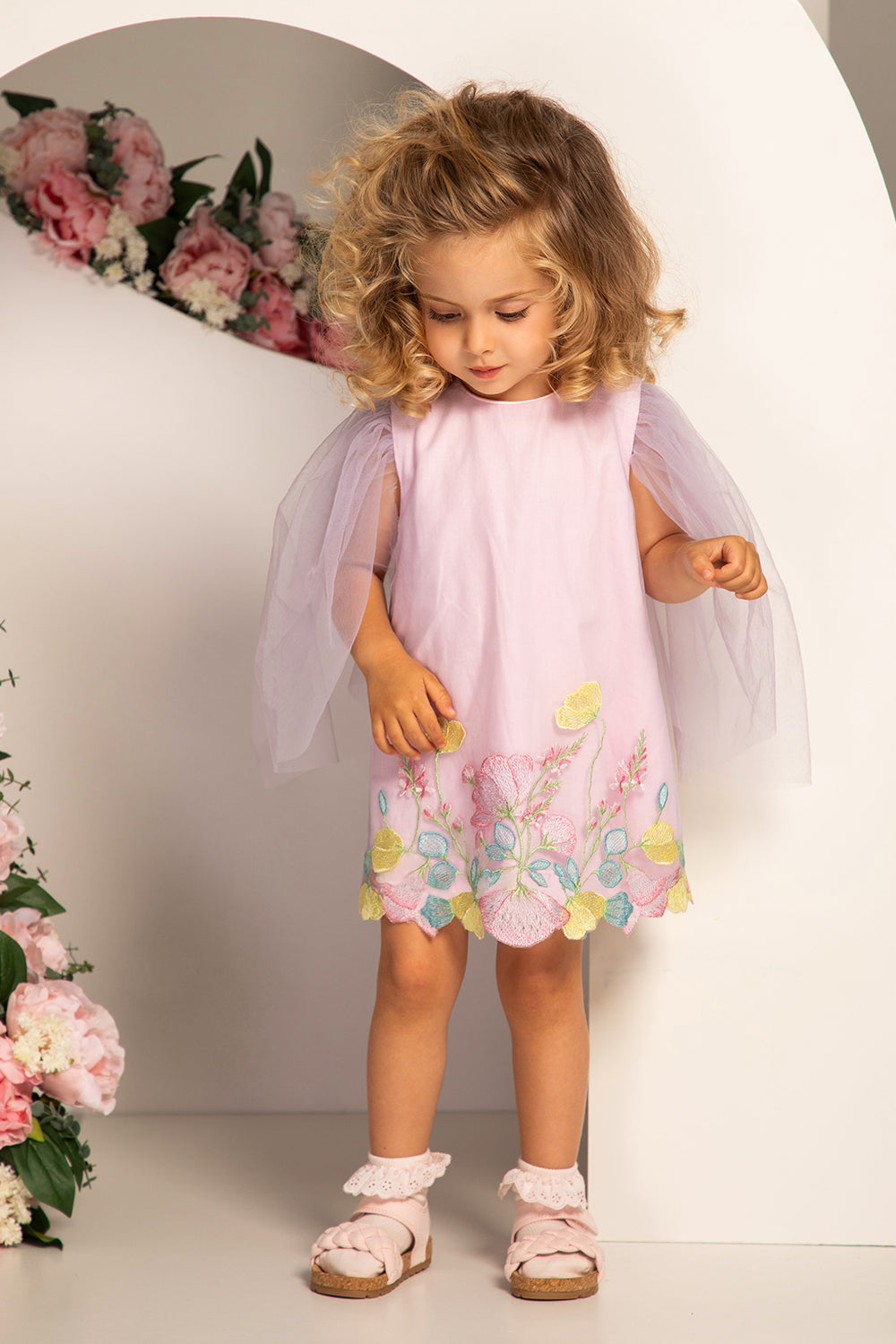 Pale lilac baby dress with pastel colors floral embroidery and tulle sleeves