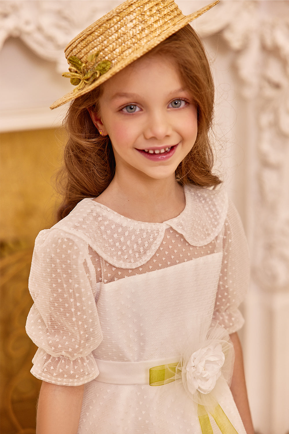 White tulle dress with green bow and flower