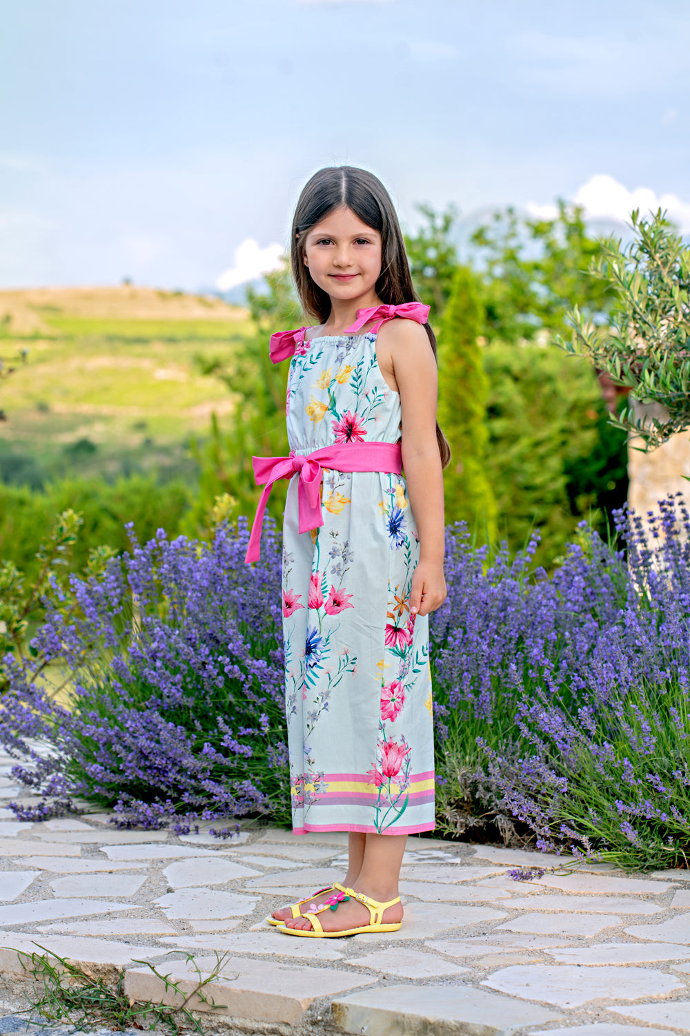 Light blue bright flowers satin cotton jumpsuit with fuchsia shoulder straps and belt