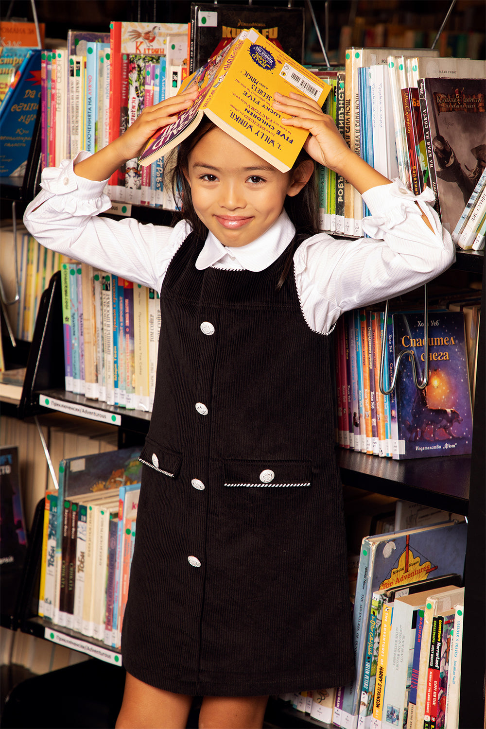 Black corduroy dress with black and white piping and white buttons