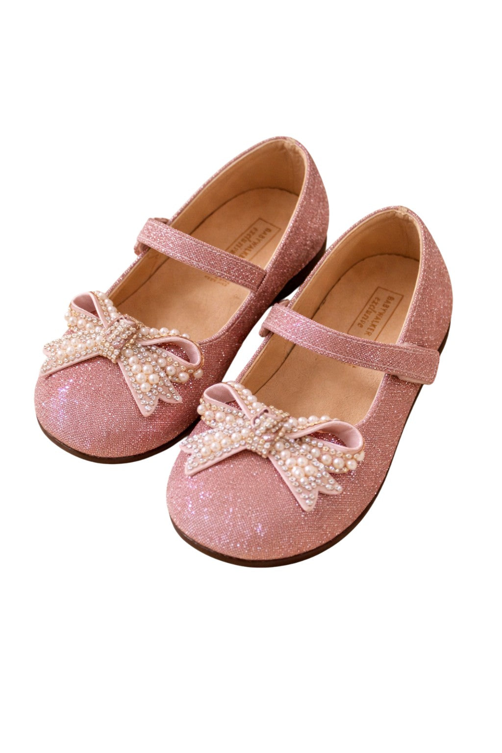 Pink glitter shoes with a decorative bow