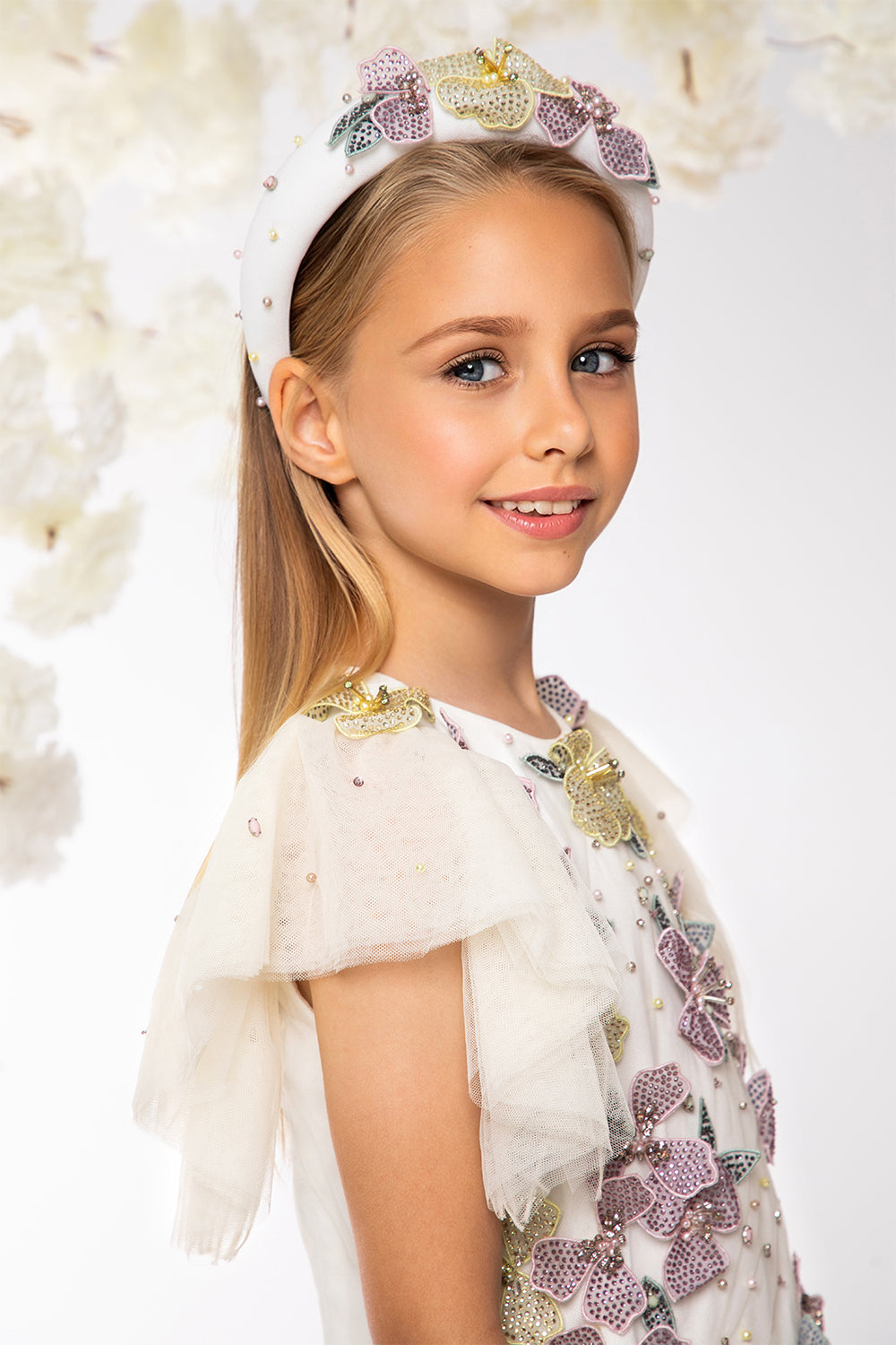 Ivory asymmetrical tulle layered dress with hand-embellished flowers, pearls and crystals and embellished waistline