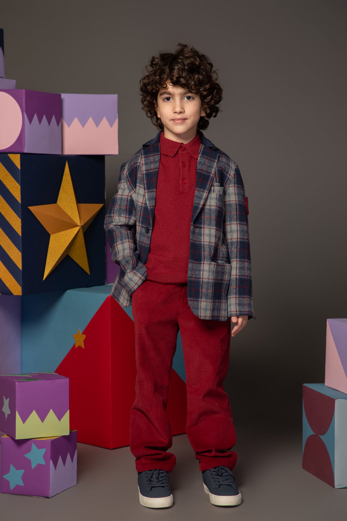 Child wearing a beige argyle cardigan