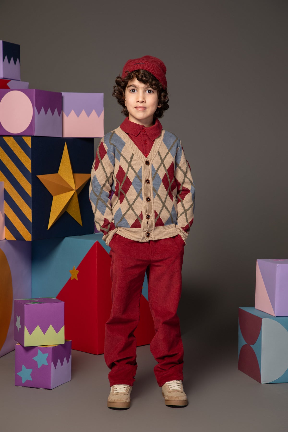 Side view of a beige cotton argyle cardigan
