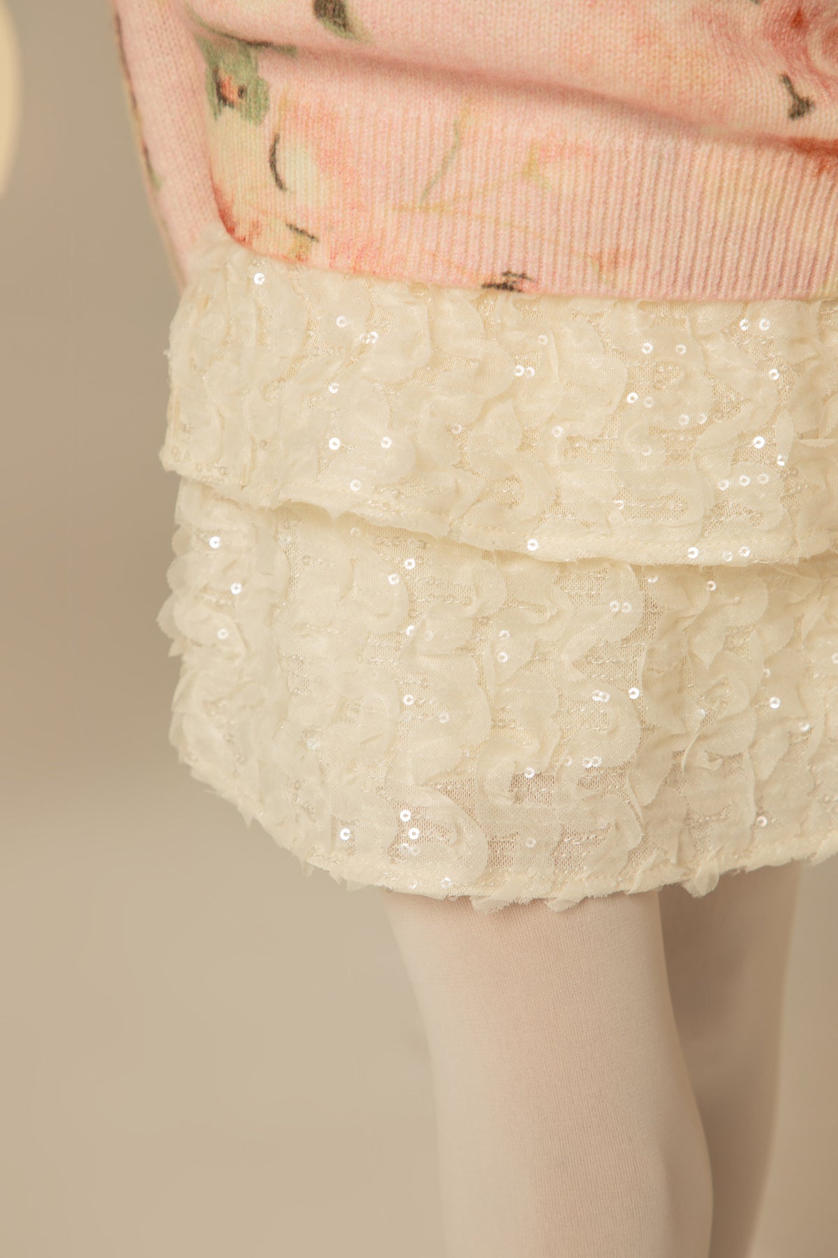 Detail of the sweater hem over the skirt
