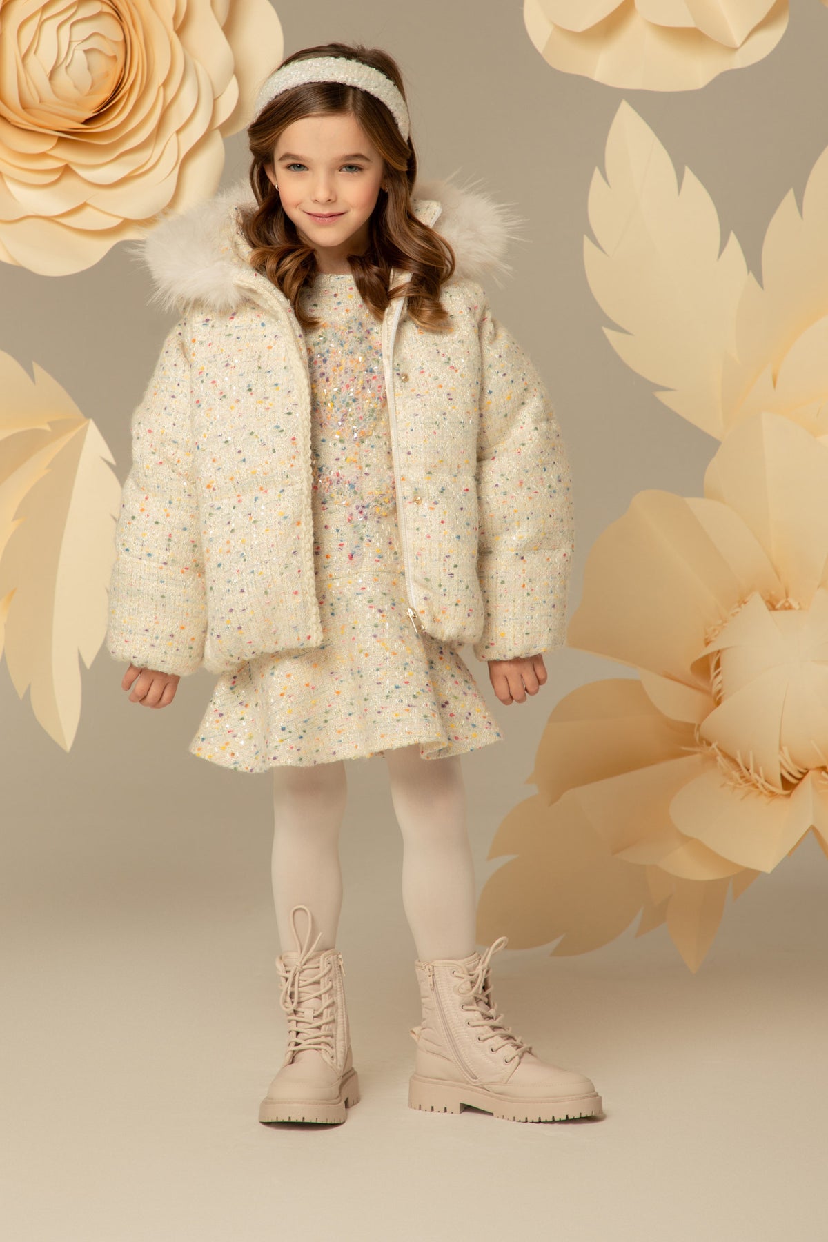 Ivory tweed jacket worn over a matching tweed dress