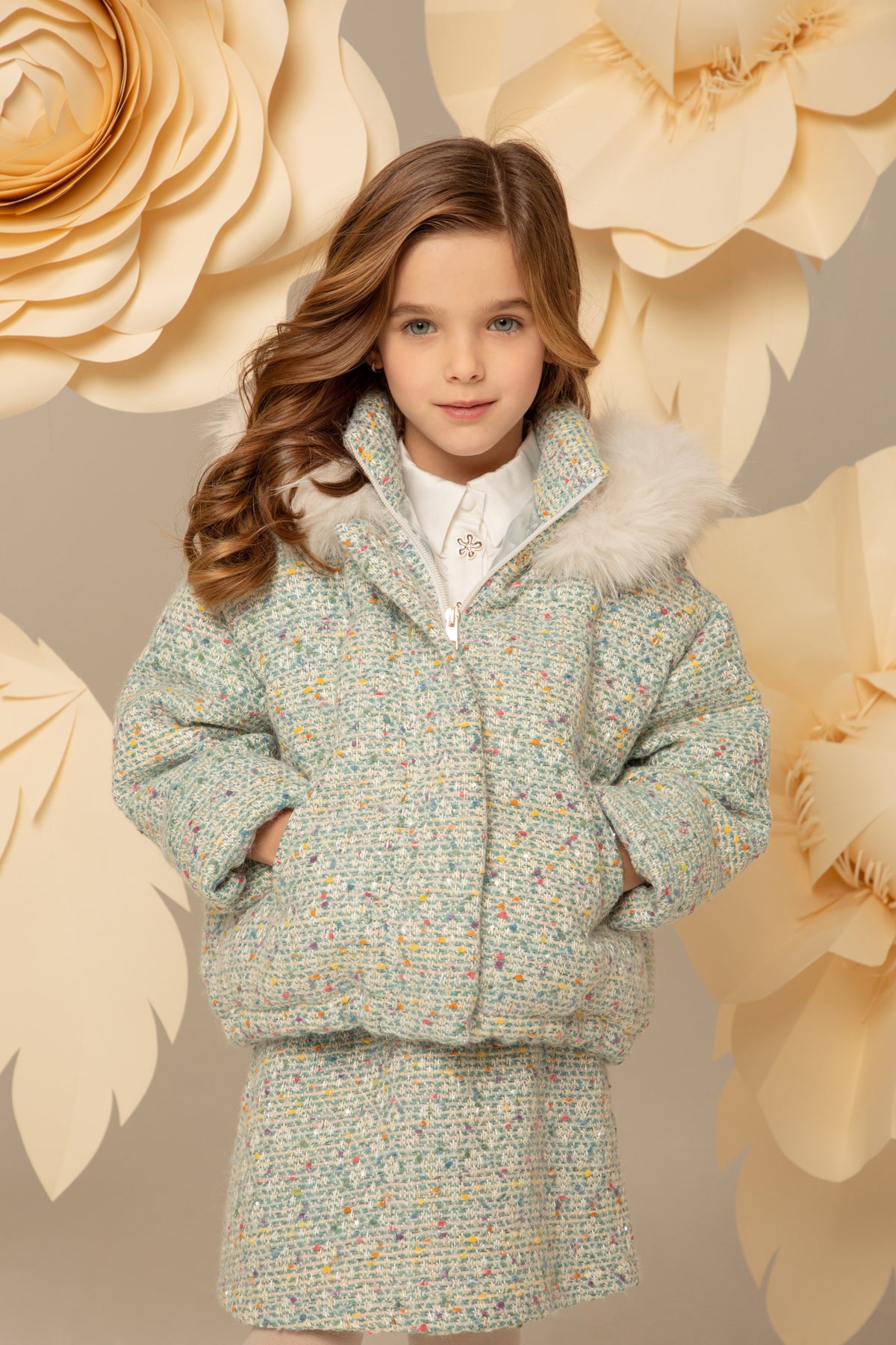 Girl wearing a mint blue tweed down jacket