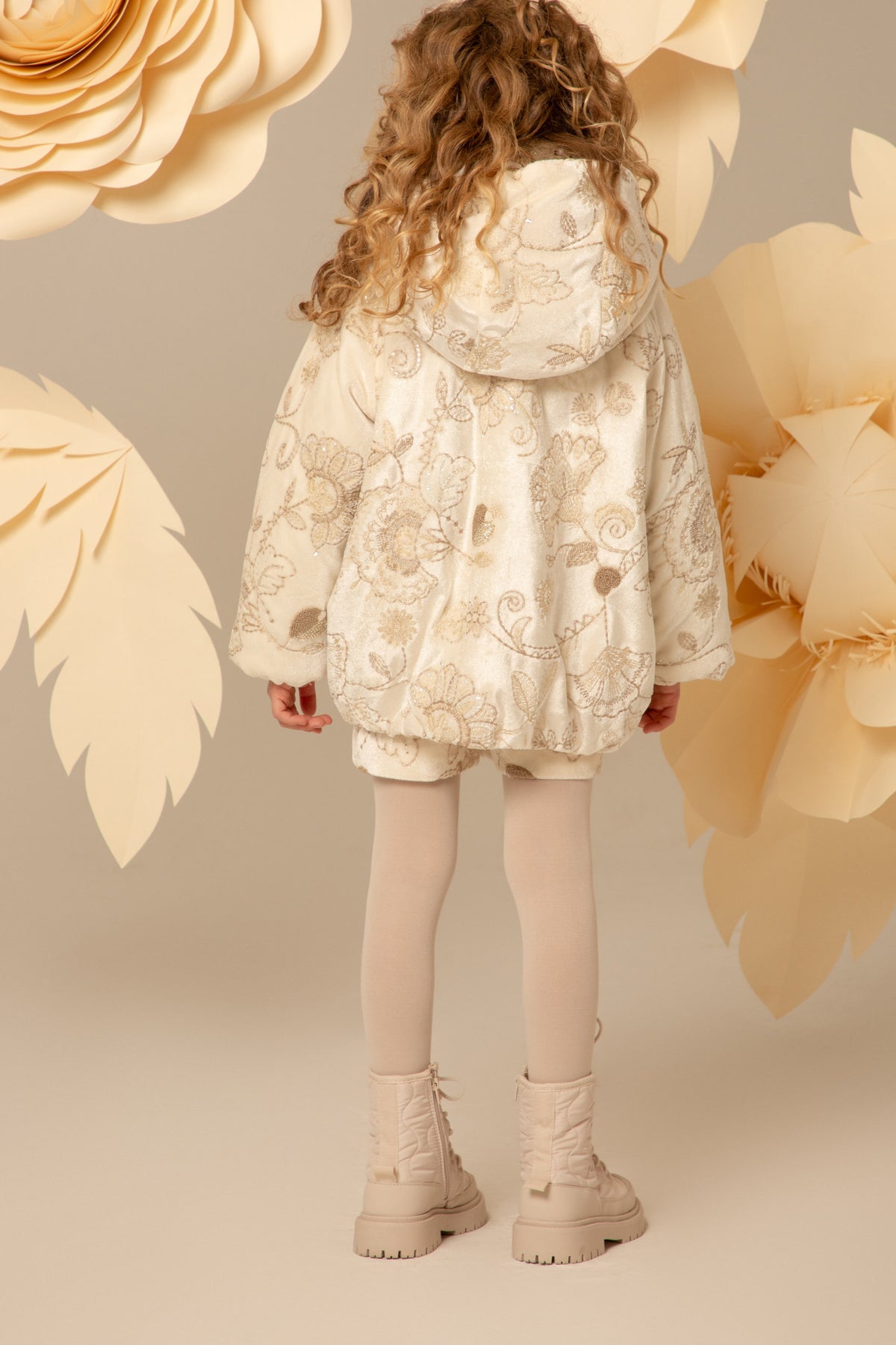 Back view of the ivory velvet padded coat