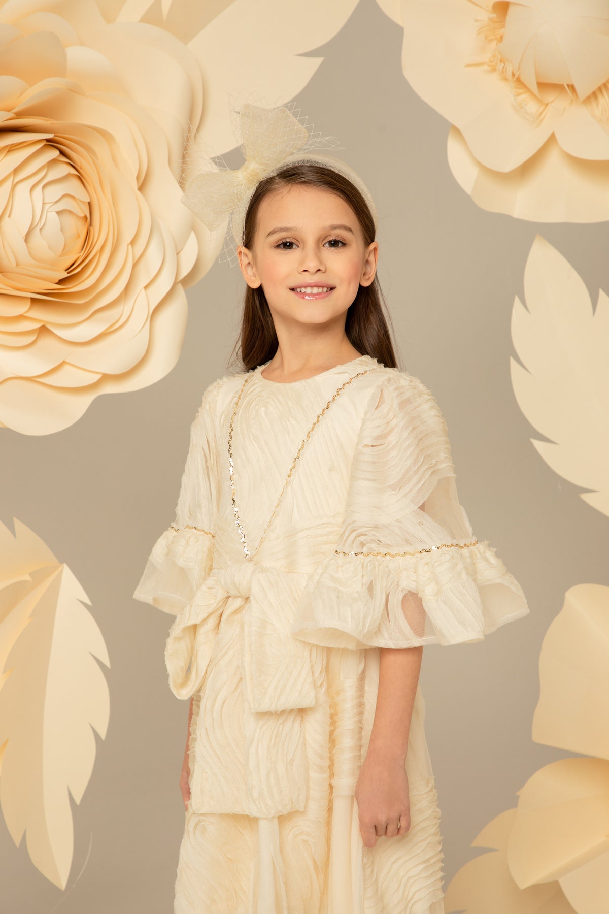 Ivory chiffon dress with an oversized bow at the waist