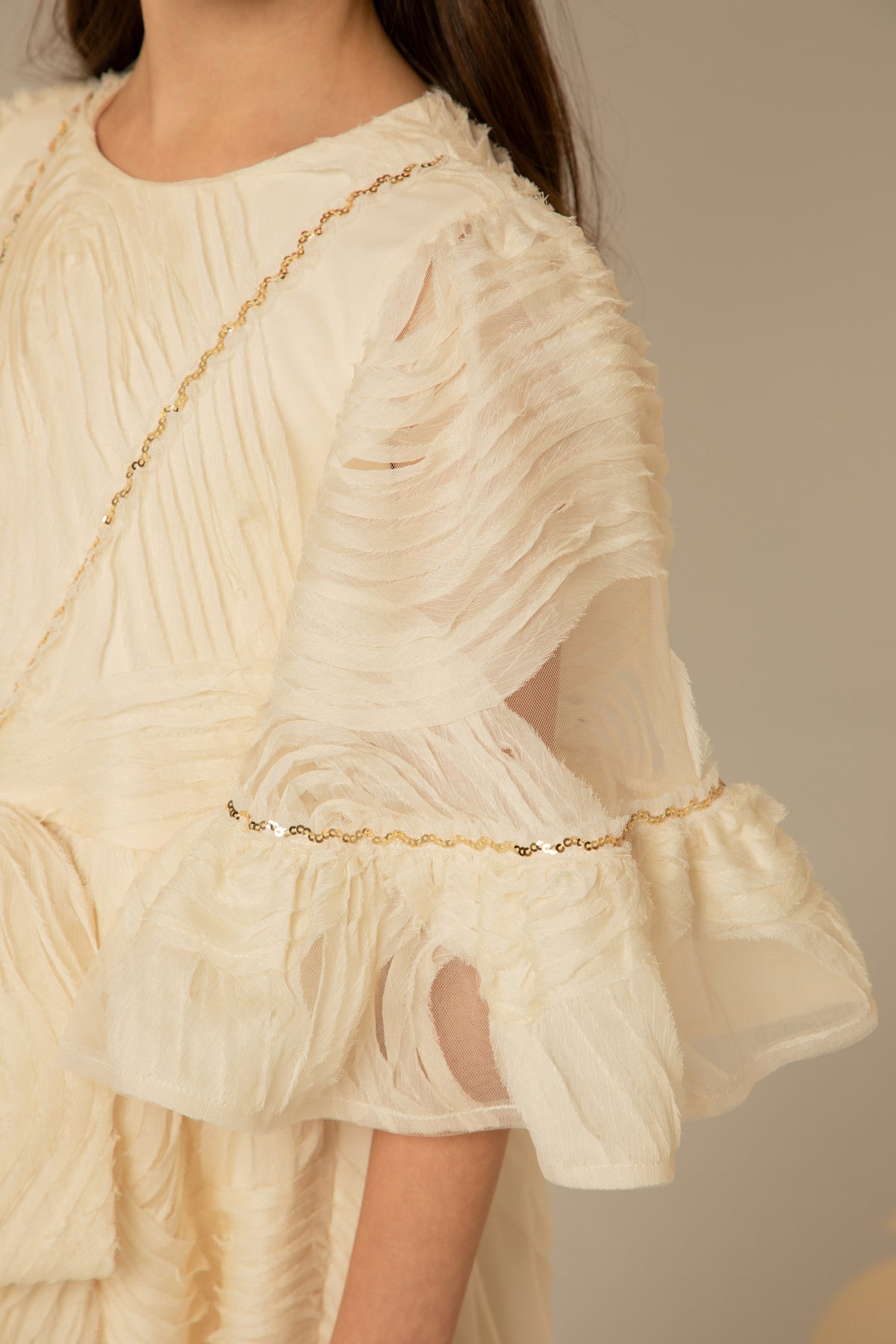 Close view of the sequinned bell sleeve