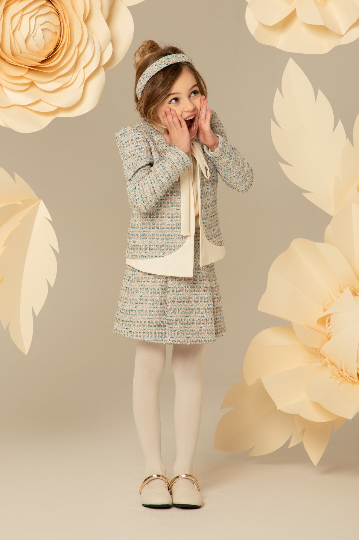 Tweed jacket and skirt set with a cream bow tie
