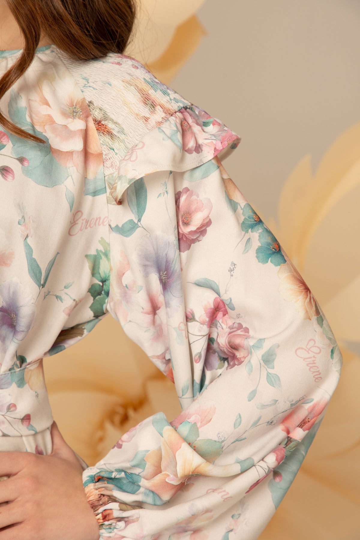 Detail of the puff sleeve and shoulder ruffle