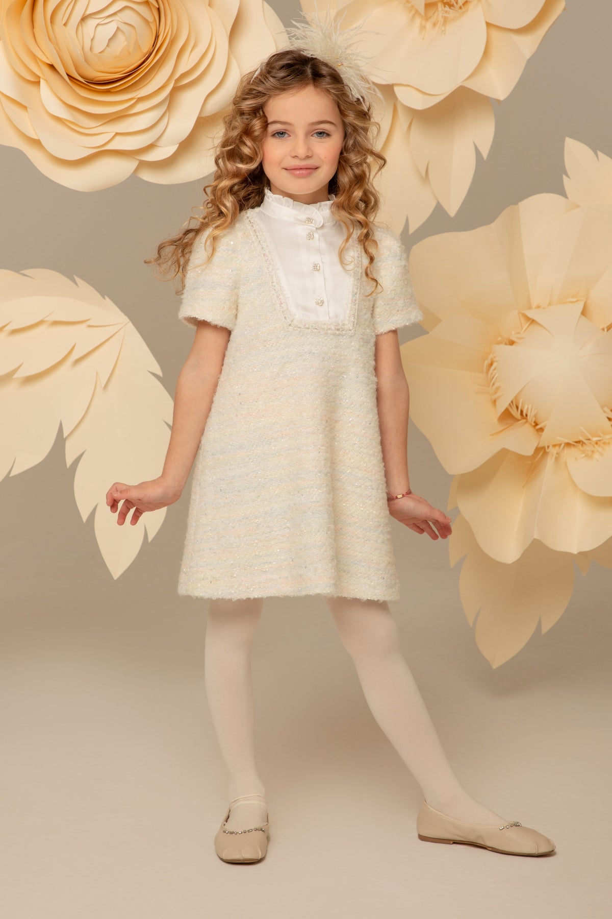 Girl wearing an ivory pastel tweed A-line dress