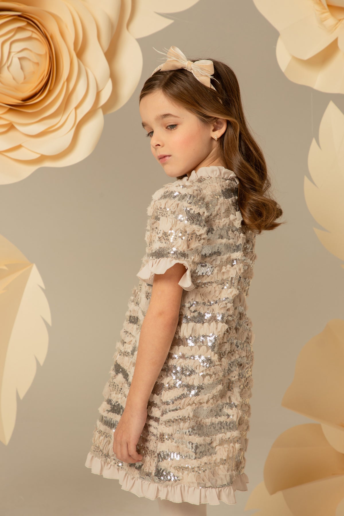 Side view of a beige sequinned A-line dress
