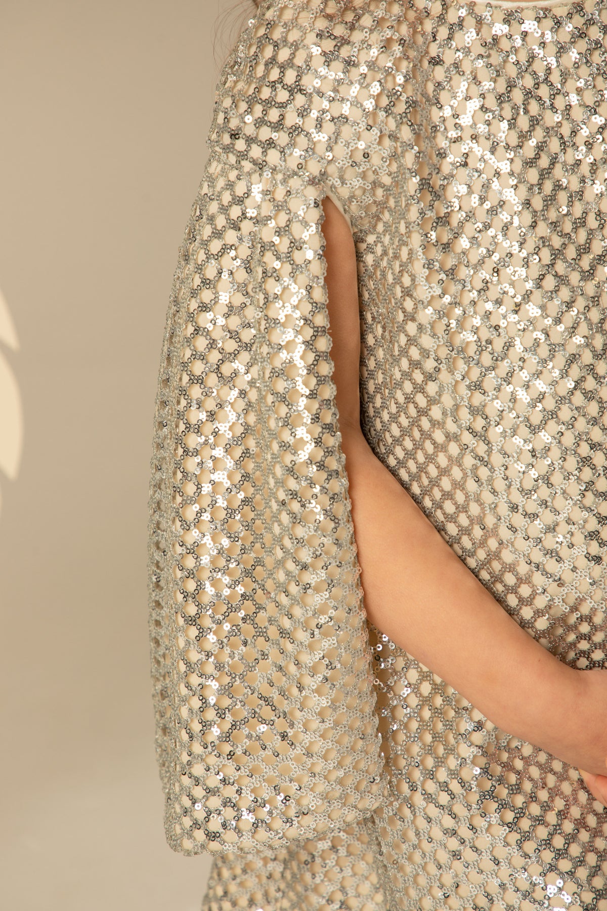 Detail of the split cape sleeve and sequins