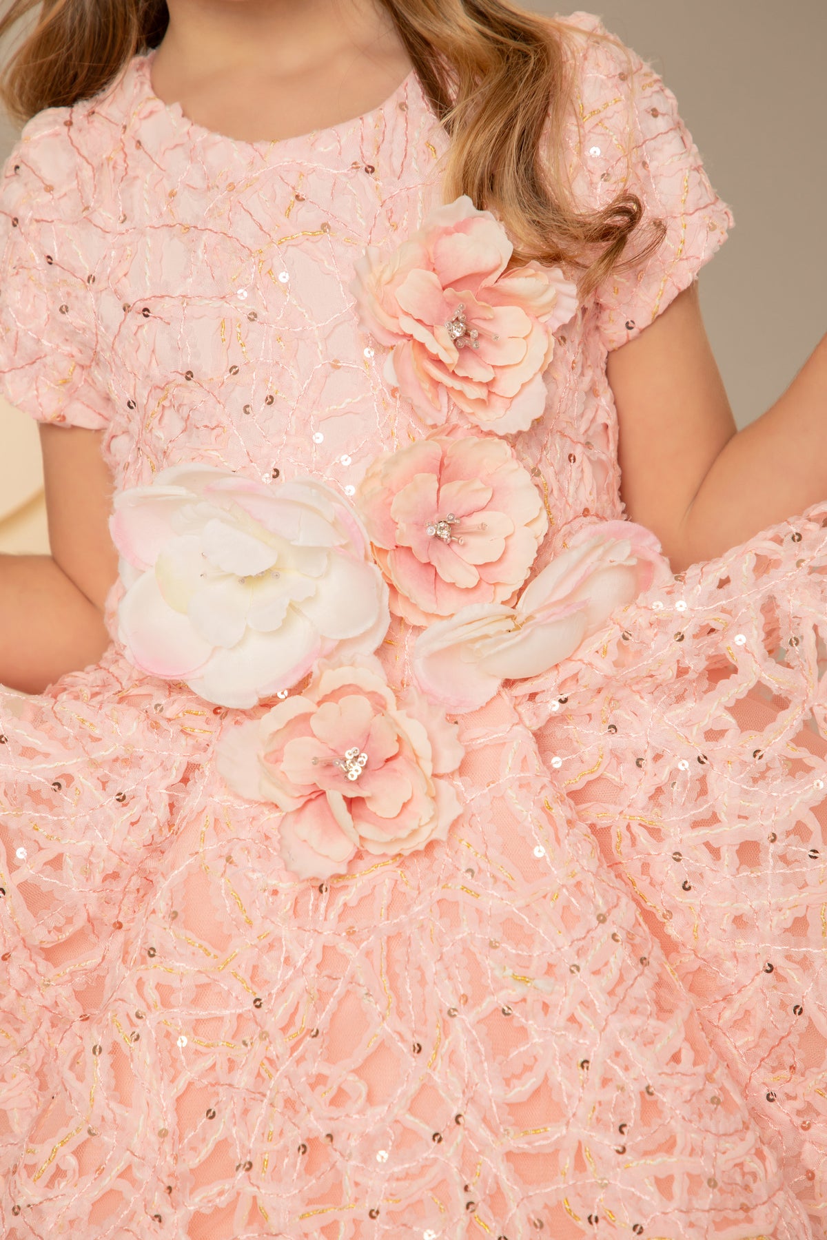 Close view of the flower appliqué at the waist