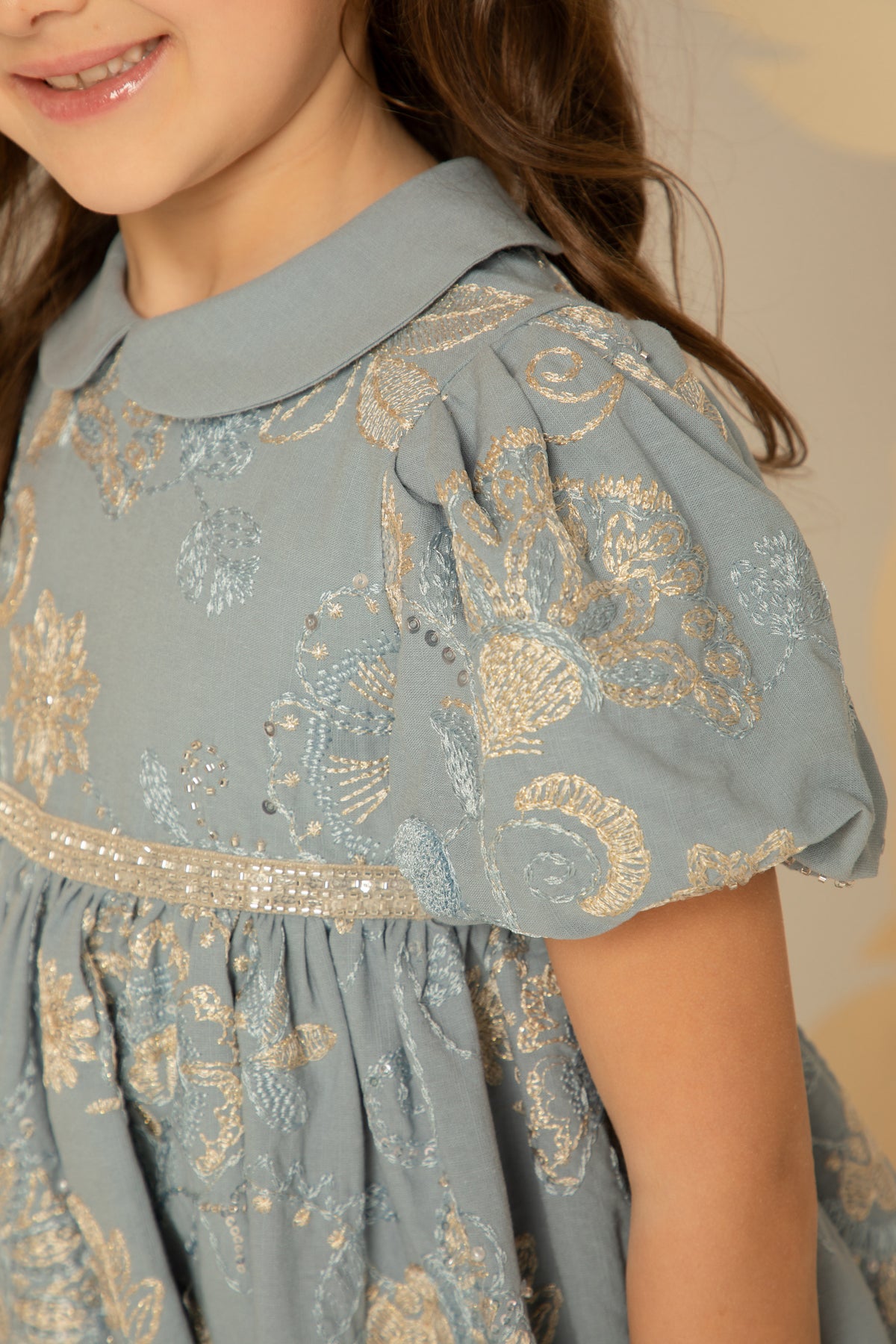 Close view of the gold floral embroidery