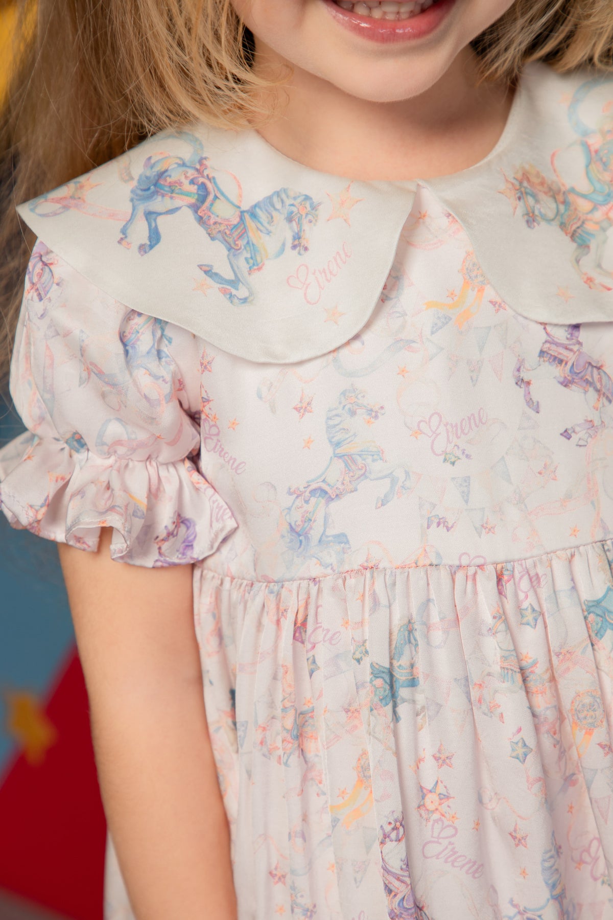 Close-up of the carousel print and ruffle sleeve