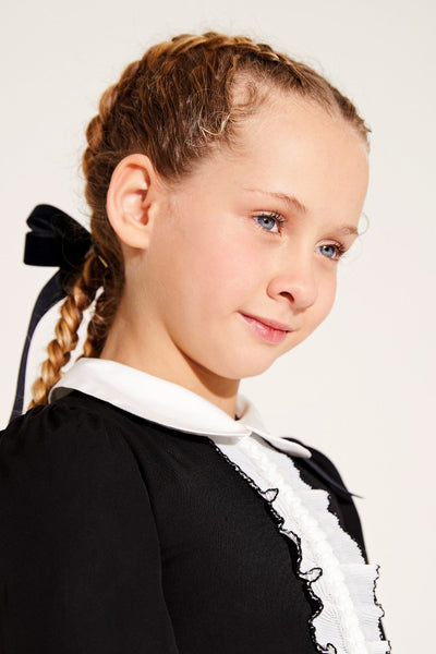 Black woven viscose-cotton girls' dress with white collar and pleated detail, ideal for special occasions.