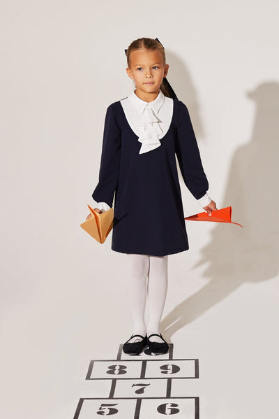 Girls' black woven dress with white collar and removable front detail for special occasions.