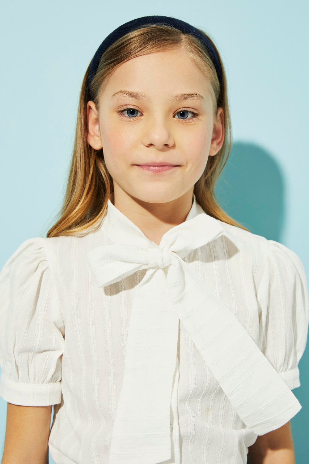 White woven embroidered cotton shirt with a pussy bow.