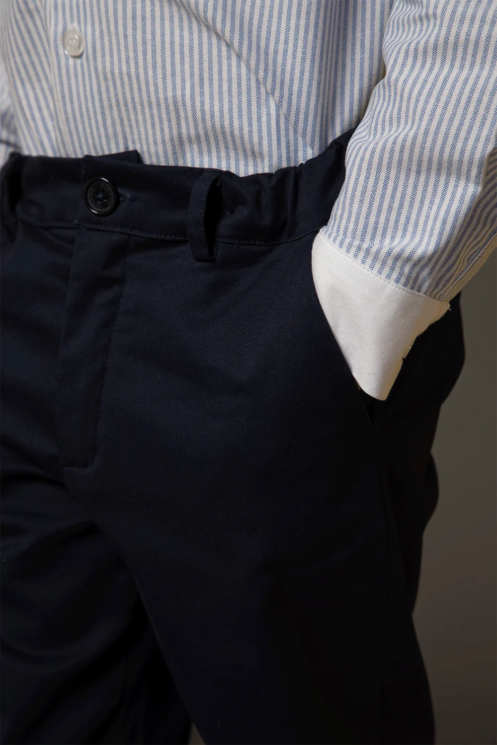 Light blue and white striped shirt with buttons, a classic collar and white cuffs