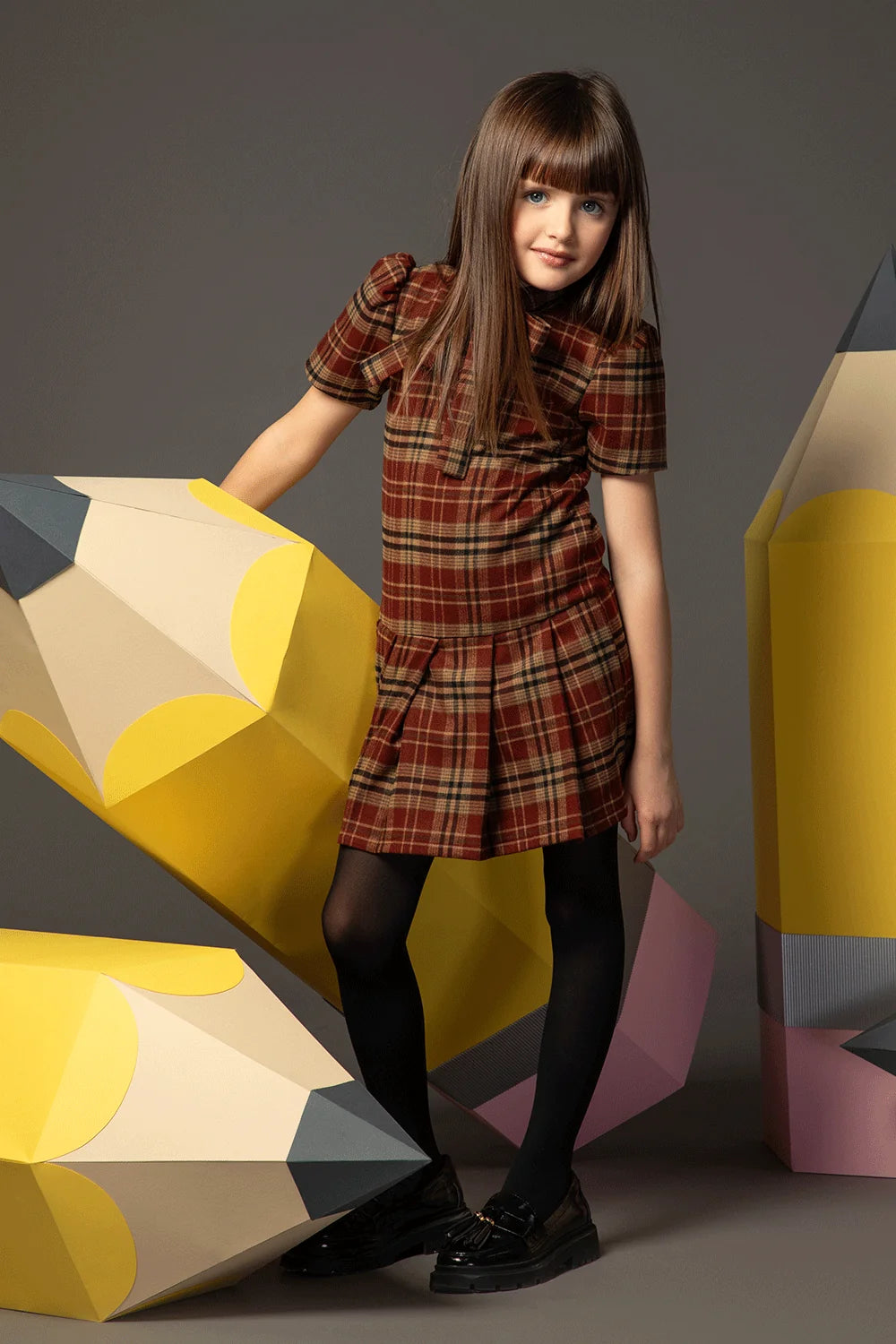Beige and burgundy checked dress with short sleeves, bow collar and pleated skirt